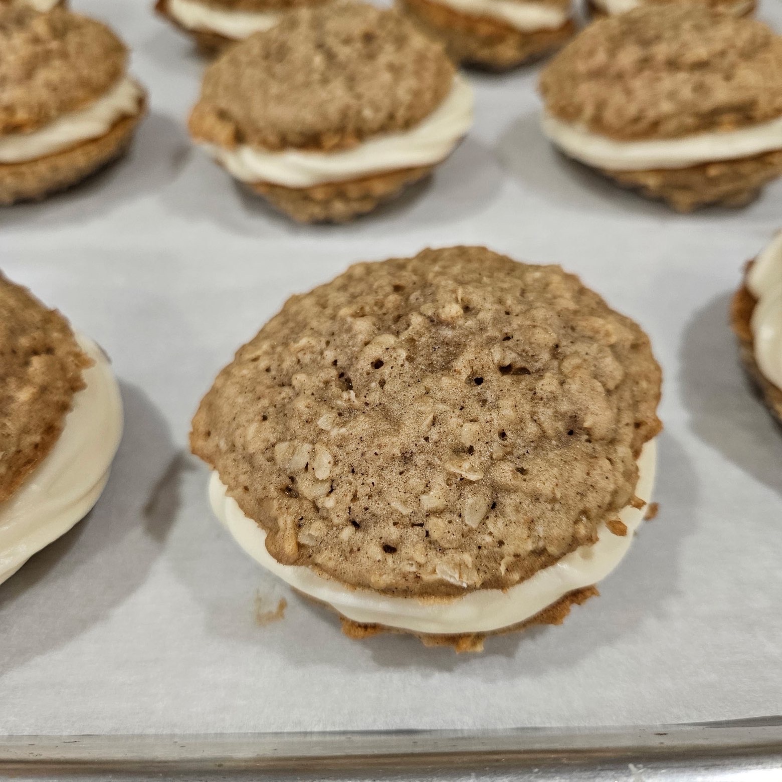 Oatmeal cream pie cookies on parchment